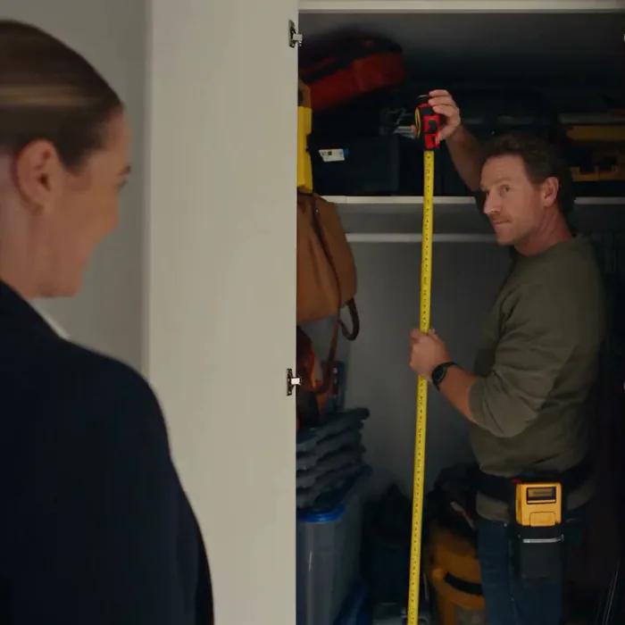 A tape measure checked against a doorway, close in
