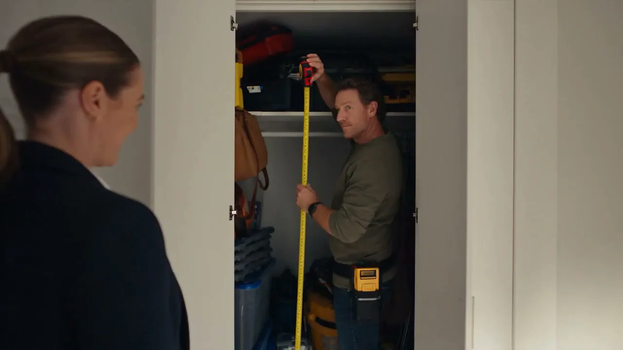 A tape measure checked in a doorway during an inspection